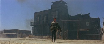 Movie still from “A Fistful of Dollars” (1964), directed by Sergio Leone – A man standing in front of an old building; Wide shot, Low angle