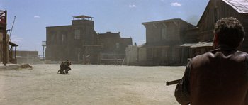 Movie still from “A Fistful of Dollars” (1964), directed by Sergio Leone – An old western town with a gun in the middle of it; Wide shot, Low angle