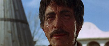 Movie still from “A Fistful of Dollars” (1964), directed by Sergio Leone – An older man with a mustache and a beard; Close Up shot, Low angle