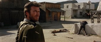 Movie still from “A Fistful of Dollars” (1964), directed by Sergio Leone – A man standing next to a dead body on the ground; Medium shot, Low angle