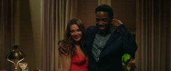 Movie still from “A Good Person” (2023), directed by Zach Braff – A man and a woman posing for a picture; Medium shot, Low angle