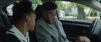 Movie still from “A Good Person” (2023), directed by Zach Braff – An older man sitting in a car with a young girl; Close Up shot, Over the shoulder angle