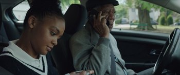 Movie still from “A Good Person” (2023), directed by Zach Braff – An older man and a young girl in a car; Close Up shot, Over the shoulder angle