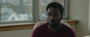 Movie still from “A Good Person” (2023), directed by Zach Braff – A person sitting in a chair; Close Up shot, Over the shoulder angle