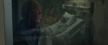 Movie still from “A Good Person” (2023), directed by Zach Braff – An older man and a woman in a hospital bed; Close Up shot, Over the shoulder angle