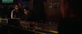 Movie still from “A Good Person” (2023), directed by Zach Braff – A man sitting at a table in front of a mirror; Medium shot, Over the shoulder angle