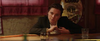 Movie still from “A Good Person” (2023), directed by Zach Braff – A woman sitting at a table in front of a glass of wine; Close Up shot, Over the shoulder angle