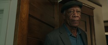 Movie still from “A Good Person” (2023), directed by Zach Braff – An older man wearing a hat and a jacket; Close Up shot, Low angle