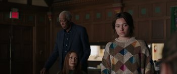 Movie still from “A Good Person” (2023), directed by Zach Braff – Two women and an older man in a room; Medium shot, Over the shoulder angle