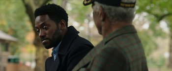 Movie still from “A Good Person” (2023), directed by Zach Braff – Two men are sitting next to each other; Close Up shot, Over the shoulder angle