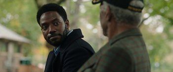 Movie still from “A Good Person” (2023), directed by Zach Braff – Two men are sitting in a forest talking; Close Up shot, Over the shoulder angle