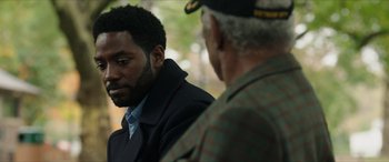 Movie still from “A Good Person” (2023), directed by Zach Braff – A man in a military uniform talking to another man in a military uniform; Close Up shot, Over the shoulder angle