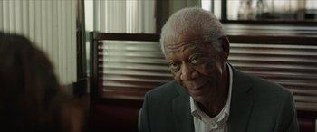 Movie still from “A Good Person” (2023), directed by Zach Braff – An older man in a white shirt and a suit; Close Up shot, Over the shoulder angle