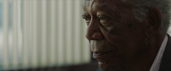 Movie still from “A Good Person” (2023), directed by Zach Braff – An old man with a very long nose looking to his left; Close Up shot, Over the shoulder angle