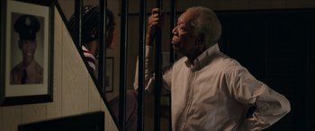 Movie still from “A Good Person” (2023), directed by Zach Braff – An older man standing next to a young man; Medium shot, Over the shoulder angle