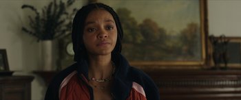 Movie still from “A Good Person” (2023), directed by Zach Braff – A young woman with braids wearing a red jacket; Close Up shot, Over the shoulder angle