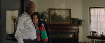 Movie still from “A Good Person” (2023), directed by Zach Braff – An older man standing next to a young woman; Medium shot, Low angle