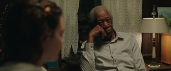 Movie still from “A Good Person” (2023), directed by Zach Braff – An older man sitting in front of a mirror; Close Up shot, Over the shoulder angle