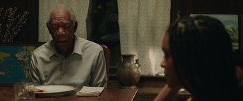 Movie still from “A Good Person” (2023), directed by Zach Braff – Two people sitting at a table in front of each other; Medium shot, Over the shoulder angle