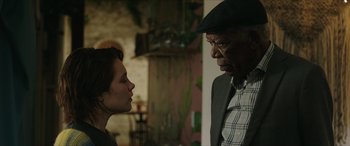 Movie still from “A Good Person” (2023), directed by Zach Braff – A man and a woman face to face in front of a brick wall; Close Up shot, Over the shoulder angle