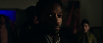 Movie still from “A Good Person” (2023), directed by Zach Braff – A person wearing a suit and tie; Close Up shot, Over the shoulder angle