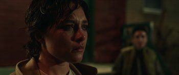 Movie still from “A Good Person” (2023), directed by Zach Braff – A person with a wet face; Close Up shot, Over the shoulder angle