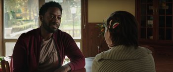 Movie still from “A Good Person” (2023), directed by Zach Braff – A man and a woman are sitting at a table talking; Close Up shot, Over the shoulder angle