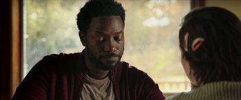 Movie still from “A Good Person” (2023), directed by Zach Braff – A person sitting in front of a window; Close Up shot, Over the shoulder angle