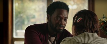 Movie still from “A Good Person” (2023), directed by Zach Braff – A person sitting in front of a window; Close Up shot, Over the shoulder angle