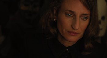 Movie still from “A Haunting in Venice” (2023), directed by Kenneth Branagh – A person wearing a black shirt; Close Up shot, Over the shoulder angle