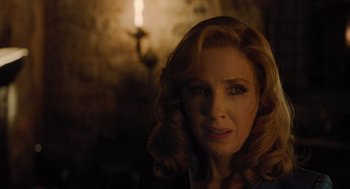 Movie still from “A Haunting in Venice” (2023), directed by Kenneth Branagh – A person wearing a suit and tie; Close Up shot, Over the shoulder angle