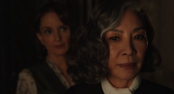Movie still from “A Haunting in Venice” (2023), directed by Kenneth Branagh – Two women standing next to each other in the dark; Close Up shot, Over the shoulder angle