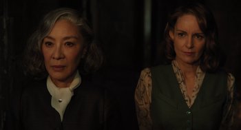 Movie still from “A Haunting in Venice” (2023), directed by Kenneth Branagh – Two women standing next to each other in front of a wall; Close Up shot, Low angle