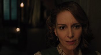 Movie still from “A Haunting in Venice” (2023), directed by Kenneth Branagh – A person wearing a green jacket; Close Up shot, Over the shoulder angle