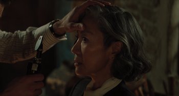 Movie still from “A Haunting in Venice” (2023), directed by Kenneth Branagh – An older woman getting her hair styled by a stylist; Close Up shot, Over the shoulder angle