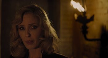 Movie still from “A Haunting in Venice” (2023), directed by Kenneth Branagh – A person wearing a black jacket; Close Up shot, Over the shoulder angle