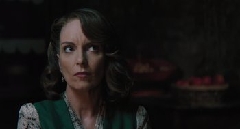 Movie still from “A Haunting in Venice” (2023), directed by Kenneth Branagh – A person looking at the camera; Close Up shot, Over the shoulder angle