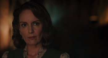 Movie still from “A Haunting in Venice” (2023), directed by Kenneth Branagh – A person wearing a green shirt; Close Up shot, Over the shoulder angle