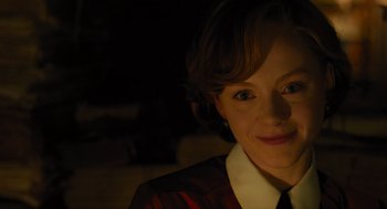 Movie still from “A Haunting in Venice” (2023), directed by Kenneth Branagh – A person wearing a suit and tie; Close Up shot, Over the shoulder angle