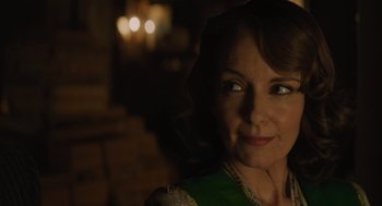 Movie still from “A Haunting in Venice” (2023), directed by Kenneth Branagh – A person wearing a green shirt; Close Up shot, Over the shoulder angle
