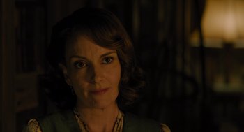 Movie still from “A Haunting in Venice” (2023), directed by Kenneth Branagh – A person wearing a necklace; Close Up shot, Over the shoulder angle