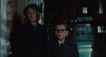 Movie still from “A Haunting in Venice” (2023), directed by Kenneth Branagh – A man and a woman standing next to each other; Medium shot, Low angle