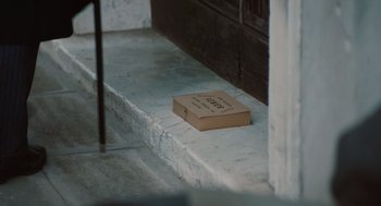 Movie still from “A Haunting in Venice” (2023), directed by Kenneth Branagh – An open book sitting on the ground on the steps; Extreme Close Up shot, High angle