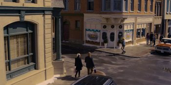 Movie still from “A Hollywood Christmas” (2022), directed by Alex Ranarivelo – Two women walking down the street holding shopping bags; Wide shot, High angle