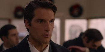 Movie still from “A Hollywood Christmas” (2022), directed by Alex Ranarivelo – A person wearing a suit and tie; Close Up shot, Over the shoulder angle