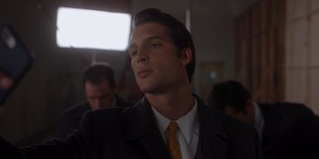 Movie still from “A Hollywood Christmas” (2022), directed by Alex Ranarivelo – A man in a suit and tie looking up; Close Up shot, Over the shoulder angle