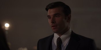 Movie still from “A Hollywood Christmas” (2022), directed by Alex Ranarivelo – A person wearing a suit and tie; Close Up shot, Over the shoulder angle