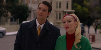 Movie still from “A Hollywood Christmas” (2022), directed by Alex Ranarivelo – A man and a woman standing next to each other on the street; Close Up shot, Low angle