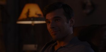 Movie still from “A Hollywood Christmas” (2022), directed by Alex Ranarivelo – A person sitting in a room; Close Up shot, Over the shoulder angle
