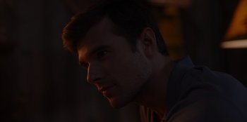 Movie still from “A Hollywood Christmas” (2022), directed by Alex Ranarivelo – A man's face in the dark; Close Up shot, Over the shoulder angle